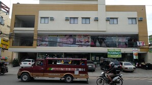 A multi-story building with a pharmacy on the ground floor. - Kiwi South (Cebu City)