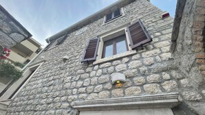 A stone building with a window and a door. - Luxury Waterfront Villa 500m2 with Private Pool and Private Beach for 14 People (Kotor)