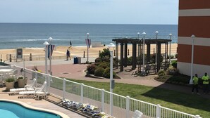 A pool area with lounge chairs, a beach view, and a gazebo. - Virginia Beach Oceanfront/Boardwalk, Beach, Pool & Balcony (Virginia Beach)