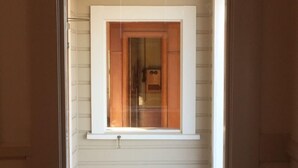 A room with a window, a door, and a small window above the door. - La Poste: historic accommodation in Amberley (Amberley)