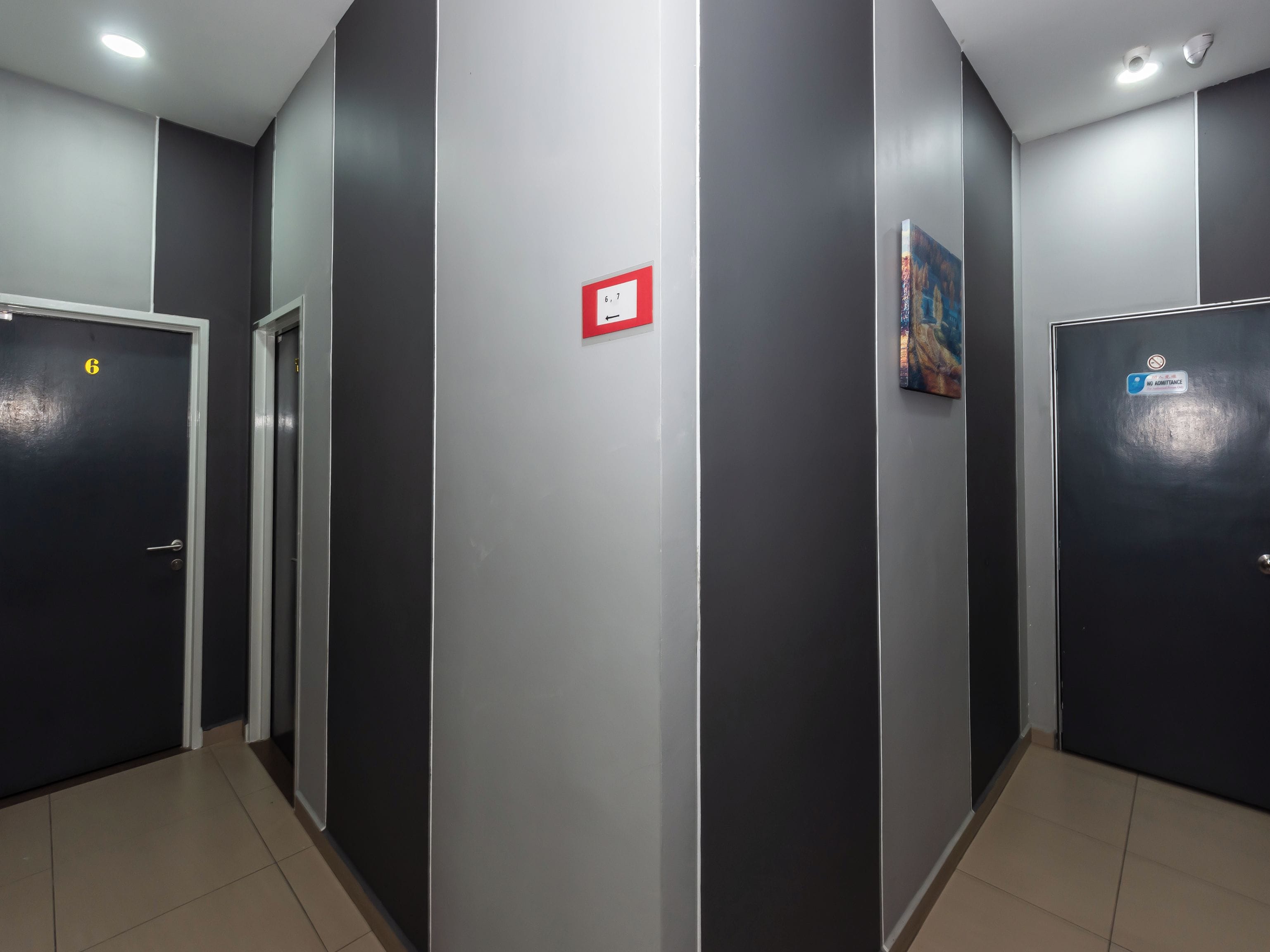 A corridor with doors, a fire alarm, and a 'No Admittance' sign.