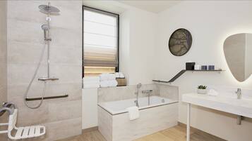 A modern bathroom with a shower, bathtub, and a vanity with a mirror.