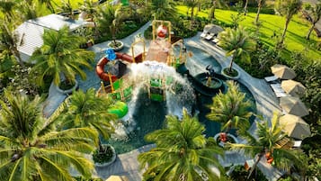 Relax in a vibrant water park surrounded by lush palm trees and well-maintained lawns.