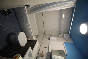 Bathtub, hair dryer, towels, soap