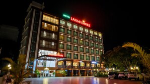 A multi-story hotel with a prominent sign reading "LAXMI EMPIRE" and "GOAN AROMA". - Hotel Laxmi Empire (Margao)