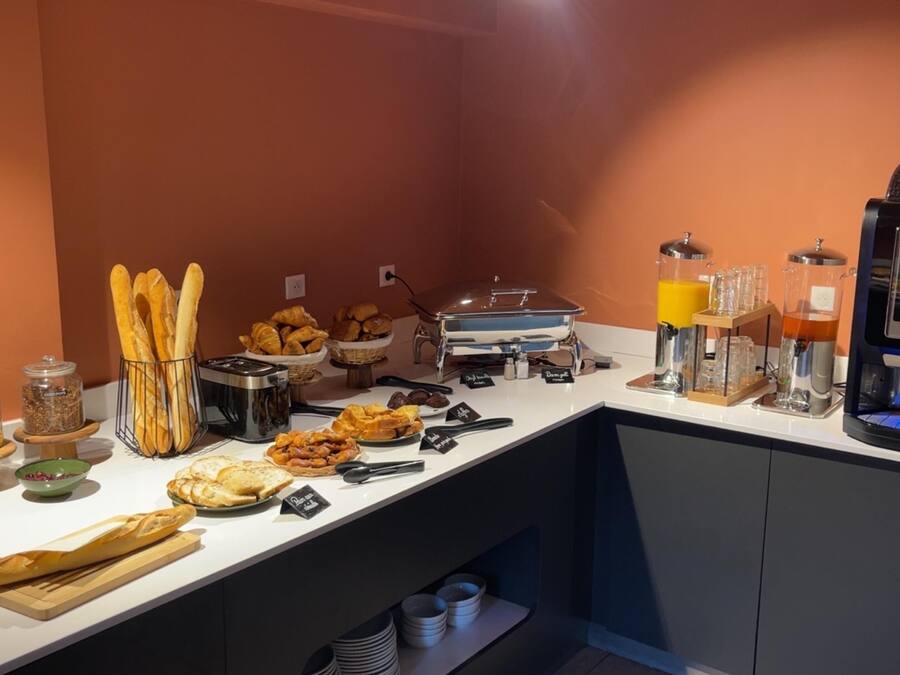 A breakfast buffet with various food items and a coffee machine.