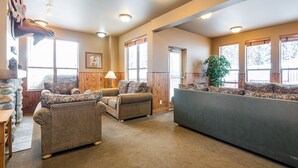 A cozy living room with two sofas, a coffee table, and a fireplace.