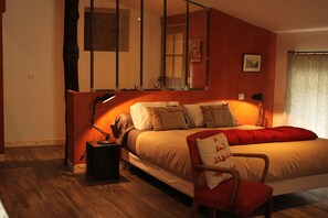 A bedroom with a bed, a chair, a desk, and a mirror. - La Demeure Des Maitres (Chirols)