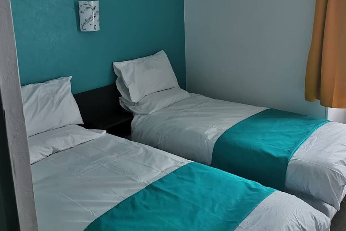 Premium bedding, laptop workspace, blackout curtains