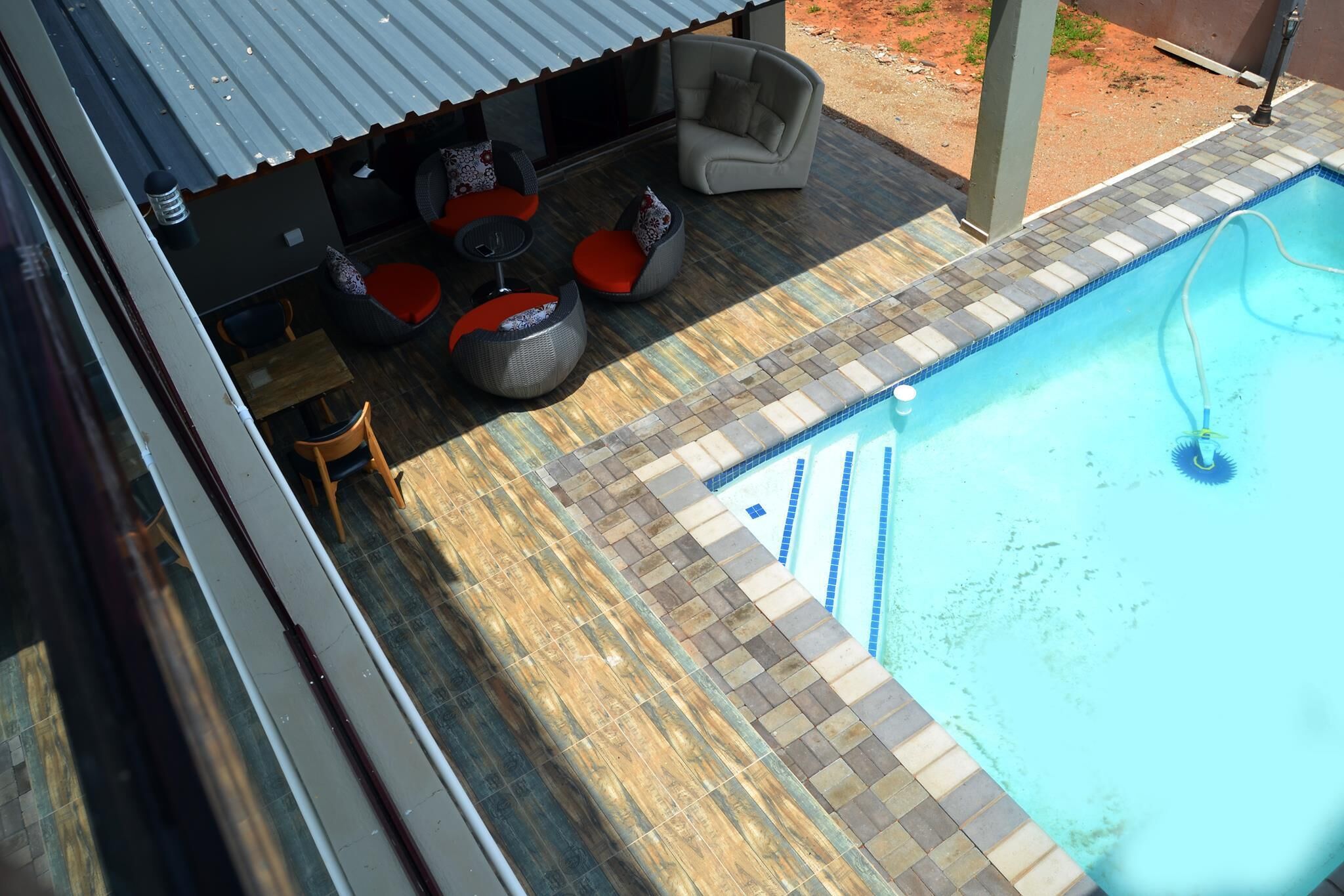 A poolside area with outdoor seating and a pool.