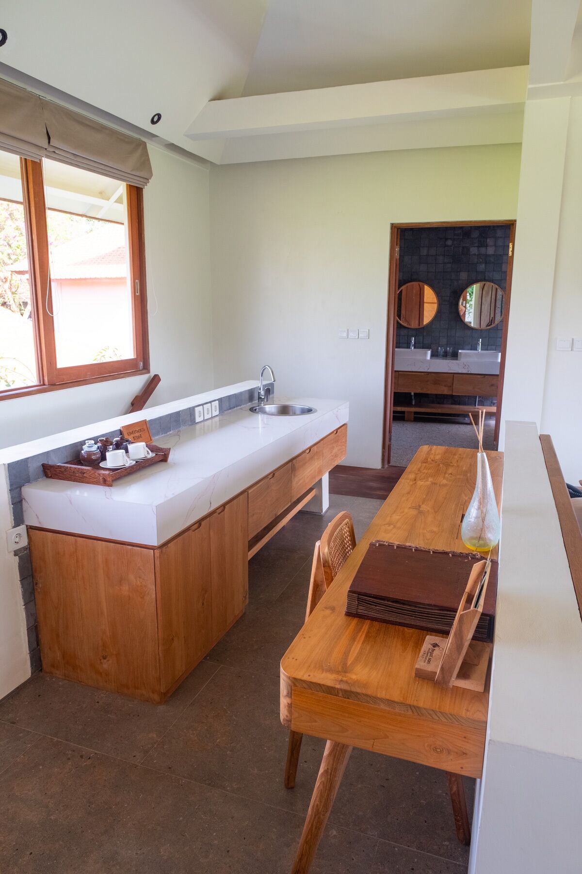 A compact kitchen with a central island, a dining table, and a built-in sink.