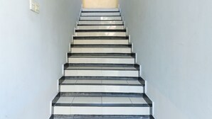 A staircase with alternating black and white steps leading upwards. - Hotel Warta Putra (Denpasar)