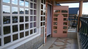 A building with a large window and a door. - Elgon Village Guest House (Eldoret)
