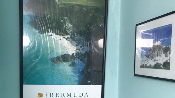 A framed photograph of Bermuda's coastline with a beach and ocean, captioned "BERMUDA". - Location! Location! AUTUMN SAVINGS at 5 Cross Bay Estate, next to Horseshoe Bay (5 Cross Bay Road)