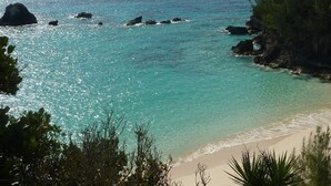 A coastal landscape with clear turquoise waters, rocky outcrops, and a sandy beach. - Location! Location! AUTUMN SAVINGS at 5 Cross Bay Estate, next to Horseshoe Bay (5 Cross Bay Road)