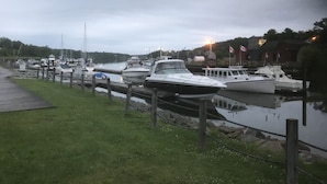 A marina with several boats docked along the water's edge.
