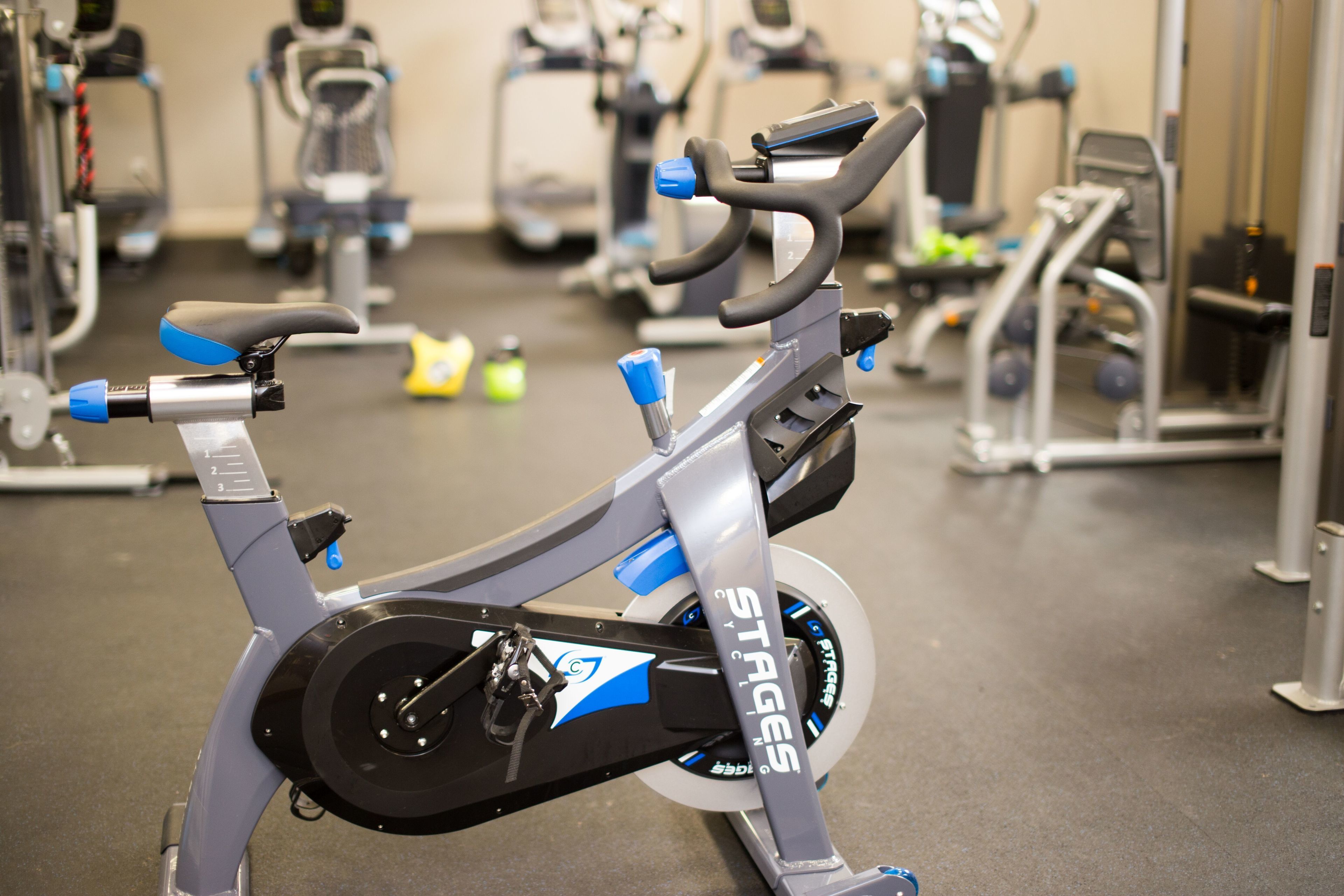 A stationary bike with a digital display and a handlebar.
