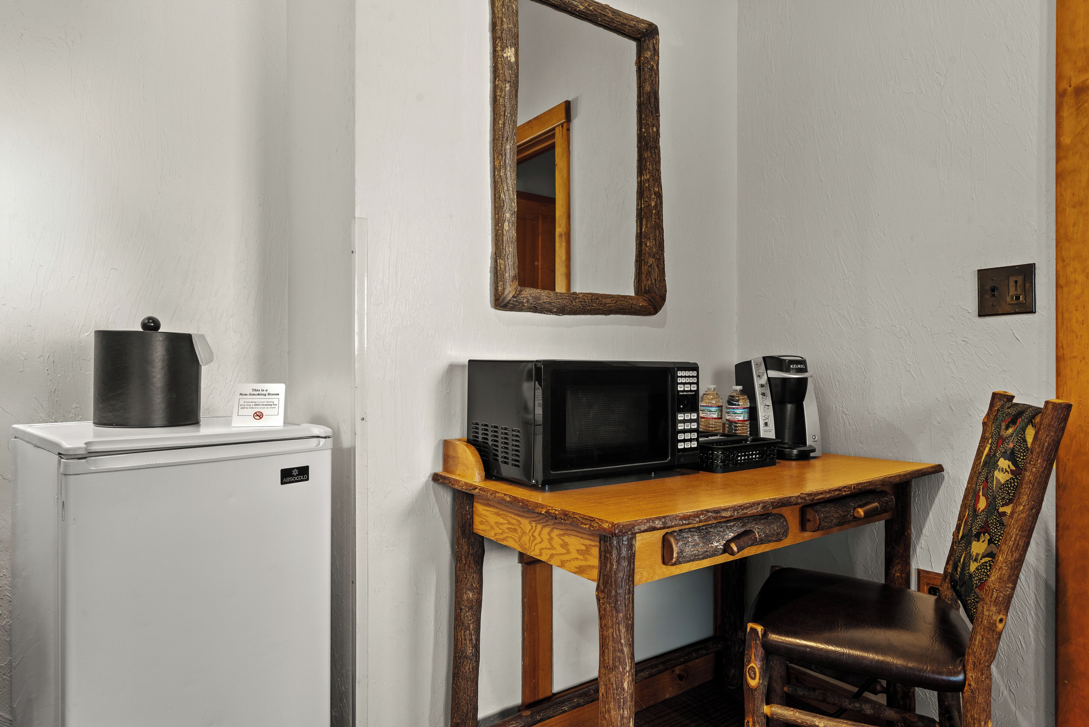 Une petite cuisine équipée d’un four à micro-ondes, d’une machine à café et d’un petit réfrigérateur.