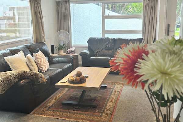 Lounge with TV looking out to the courtyard. Heatpump for climate control