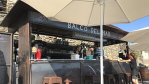 A bar named "BALCO DEL MAR" with a rustic stone wall backdrop, a counter with various bottles and glasses, and wicker bar stools. - House in beautiful Collioure with pool and sea views from both balconies (Collioure)