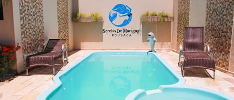 Outdoor pool, open 8:00 AM to 8:00 PM, pool loungers