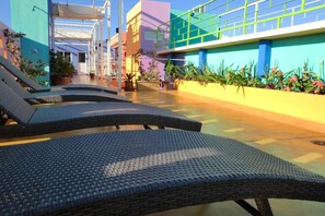 Outdoor pool, open 9:00 AM to 10:00 PM, pool loungers