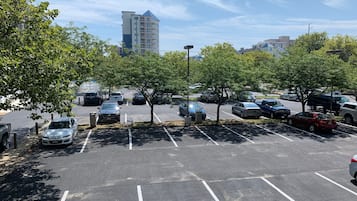 Un estacionamiento con varios coches y árboles.