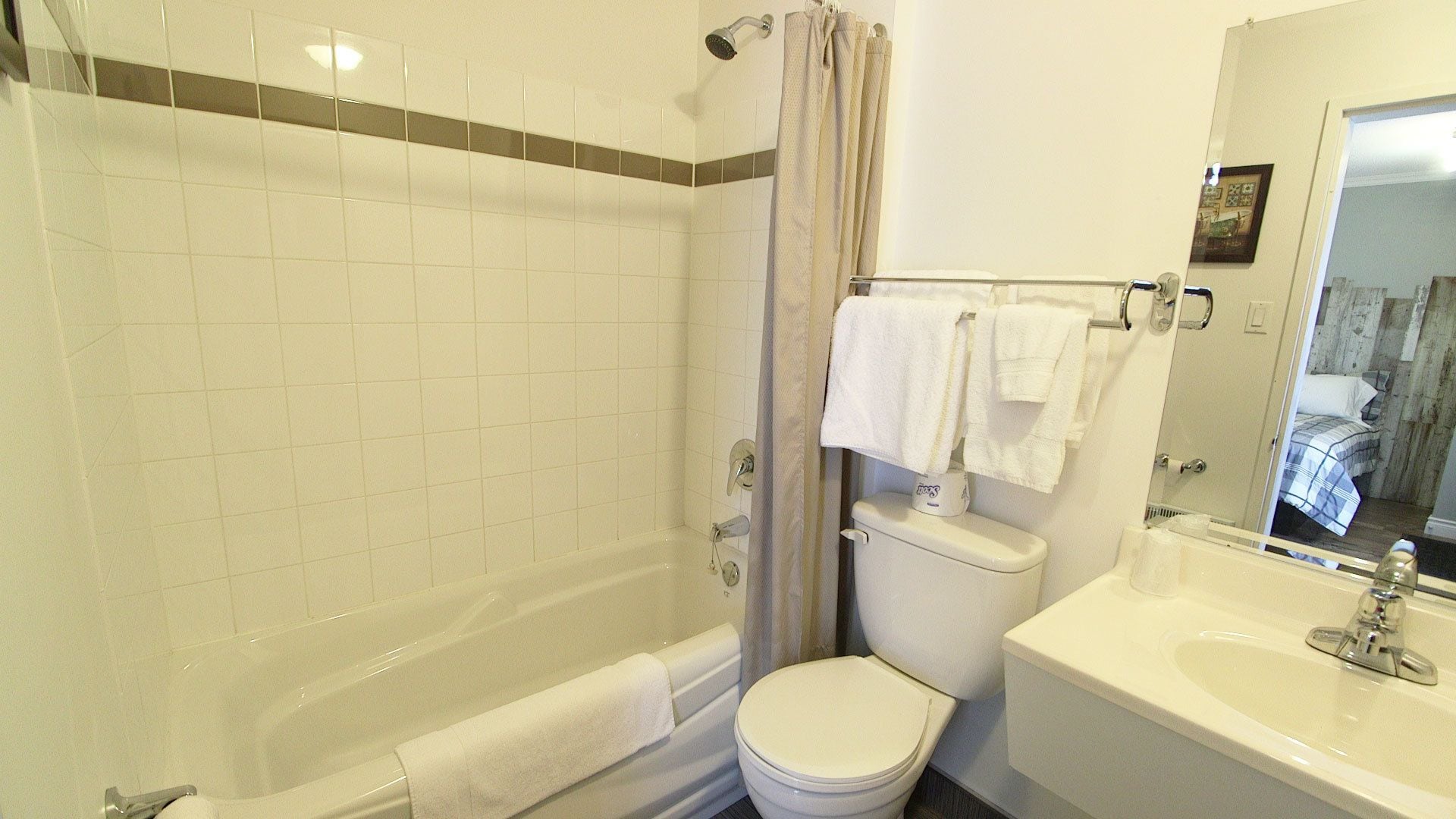 A bathroom with a bathtub, toilet, and sink.