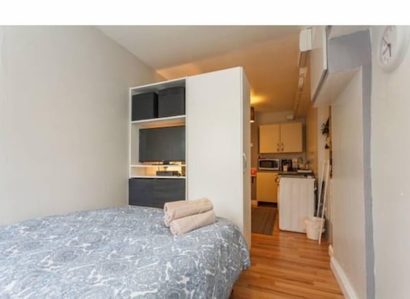 Cozy retreat with a neatly made bed and wardrobe for ample storage.
