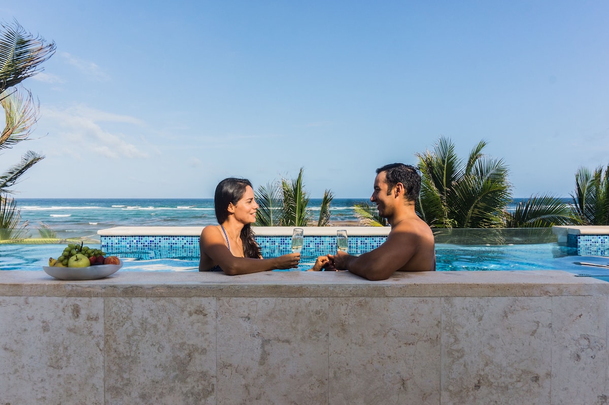 couple swimming in one of the best Casa Coral Luxury Condos pool