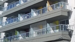 A multi-story building with balconies, large windows, and a modern architectural design. - Palermo Market Luxury apartaments (Buenos Aires)