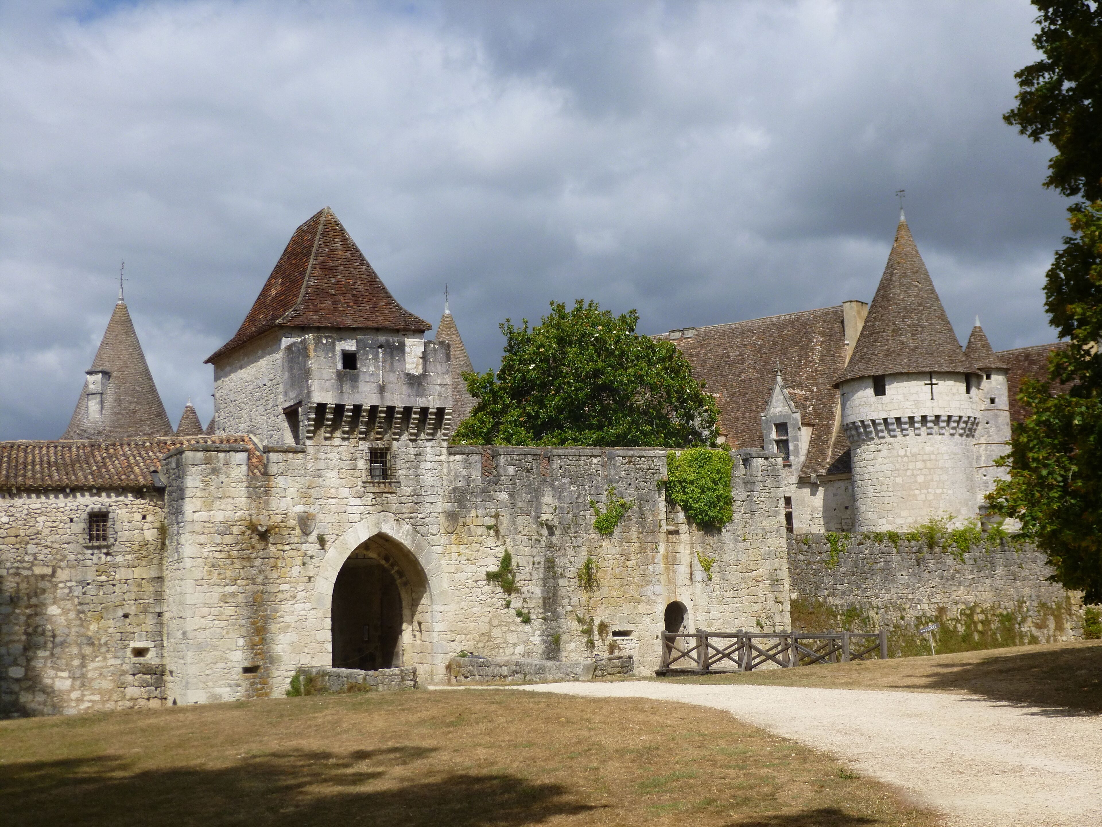 A historic stone castle with multiple towers and a large arched entrance.