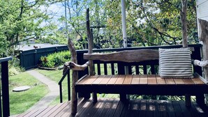 A wooden deck with a bench and a cushion. - Ohope Beach  2Brm Weekender escape,handy to beach & more! (Ohope)