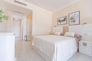 A bedroom with a bed, bedside tables, and a wardrobe.
