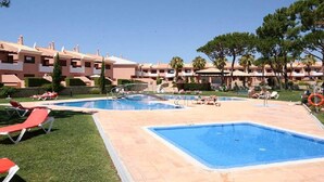 A resort with multiple swimming pools, sun loungers, and a clear blue sky. - Beautiful 3 bedroom townhouse located in Vila Sol in the heart of the Algarve  (Quarteira Vilamoura)
