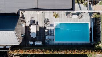 A heated pool, sun loungers