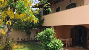 A two-story building with a covered patio area.