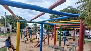 A playground with colorful equipment and benches.