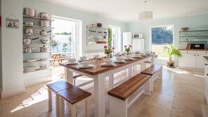 A modern kitchen with a central island, white cabinetry, and a breakfast bar.