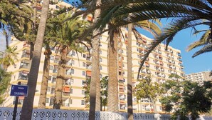 A multi-story building with balconies, surrounded by palm trees. - 5 minutes from the beach :Apartment Orange Trees panoramic ocean view (Los Cristianos)