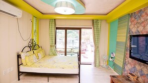 A bedroom with a bed, curtains, a ceiling fan, and a television on the wall. - Ulsan Edelweiss Pension (Ulsan)