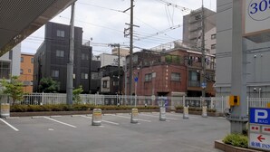 A parking lot with marked lanes and a sign indicating a hotel entrance. - Toyoko Inn Osaka Tenjimbashi-suji Rokuchome (Osaka)