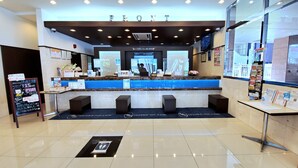 A hotel reception area with a marble counter, seating, and a digital display. - Toyoko Inn Osaka Tenjimbashi-suji Rokuchome (Osaka)