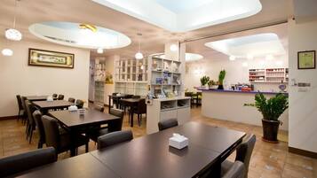 A modern dining area with tables, chairs, and a central counter.