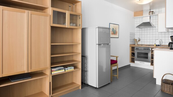 A modern kitchen with wooden cabinets, a stainless steel refrigerator, an oven, and a coffee maker. - Bad Honnef FeWo Rosenbogen (Bad Honnef)