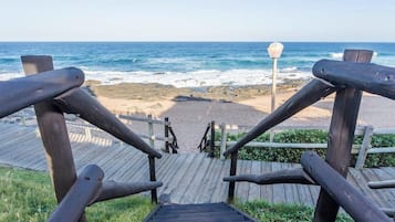 On the beach, white sand, sun loungers, beach umbrellas