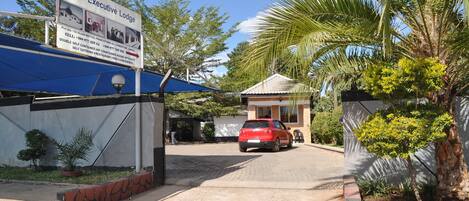 A sign for Wilu Executive Lodge with contact details and amenities listed.