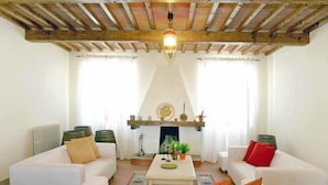 A living room with two white sofas, a coffee table, and a fireplace. - Villa Beboli per 18 pax by Interhome (Vinci)