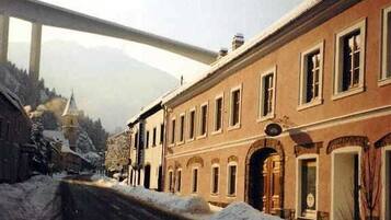A historic building with arched doorways and a prominent entrance.