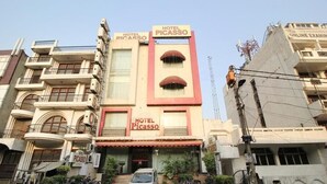 A building with multiple signs reading "HOTEL PICASSO." - Hotel Picasso (New Delhi)